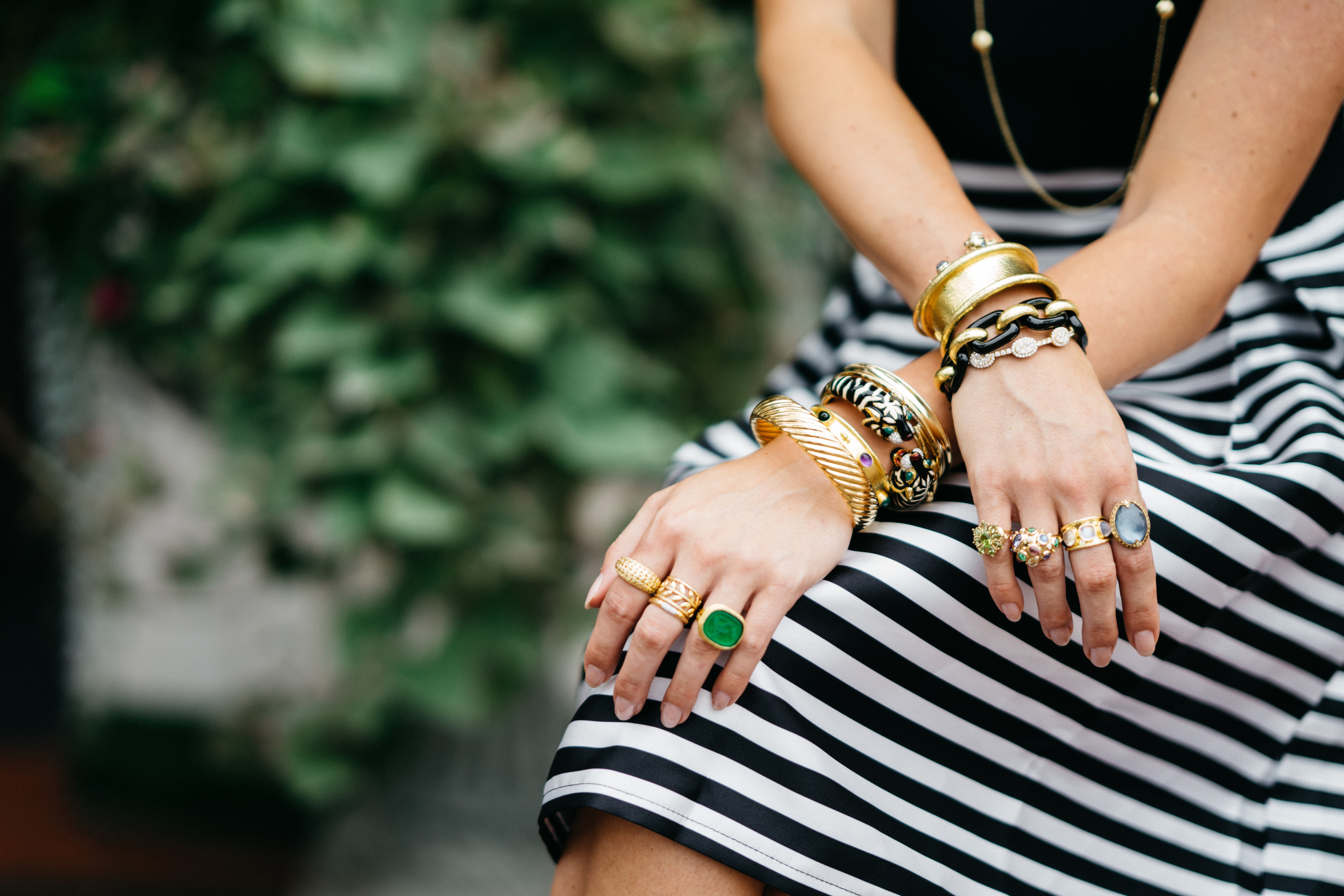 Woman sitting with jewelry on arms